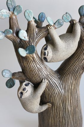 céramique représentant un arbre aux feuilles bleues avec deux paresseux